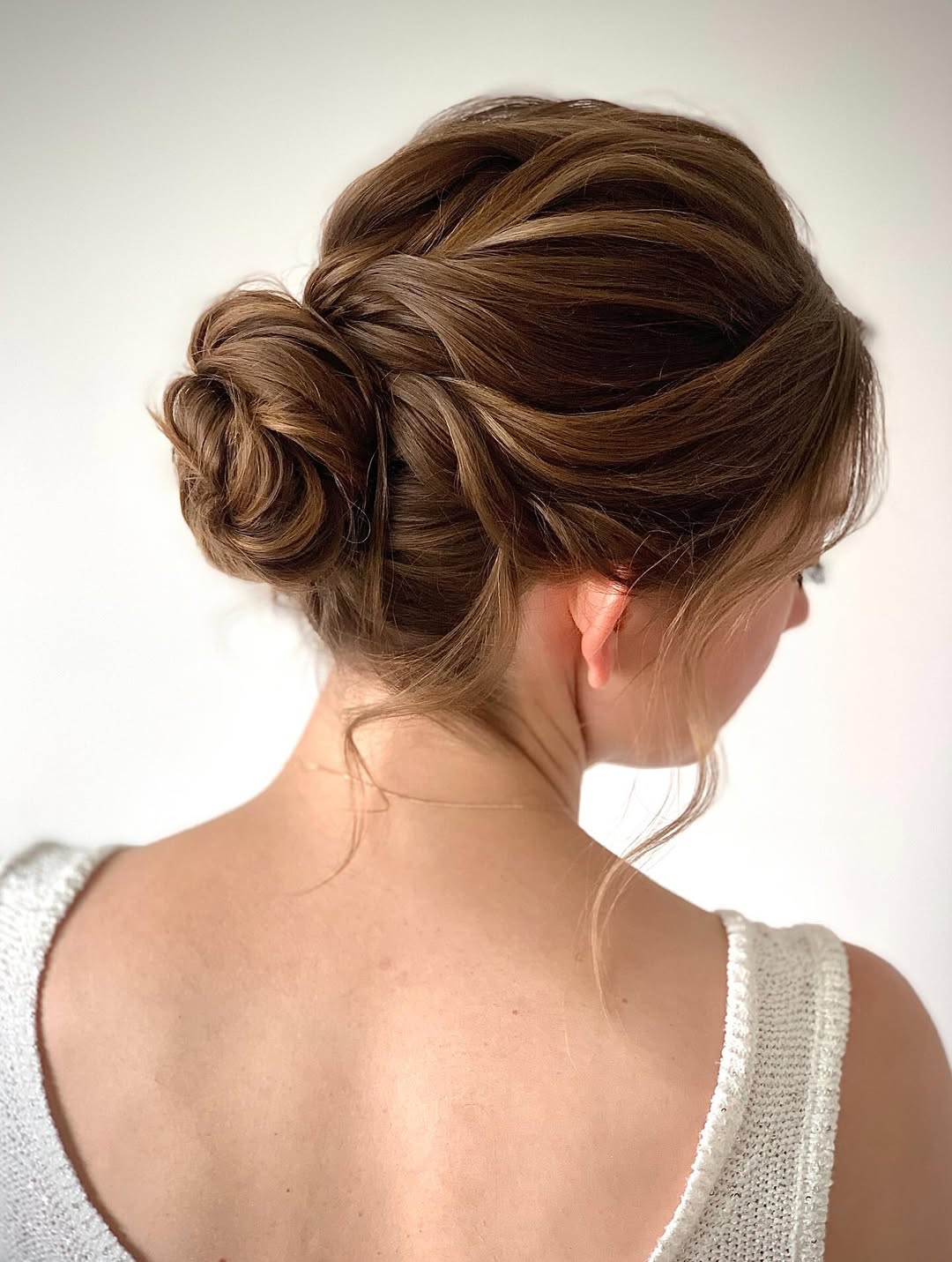 14 Formal Hairstyles Ideas That'll Make You Look Like You Have a Personal Stylist (DIY in 10 Minutes Flat!) 10 Textured Low Bun with Face-Framing Pieces