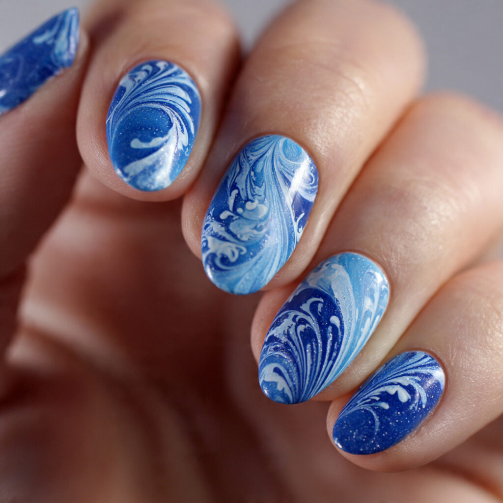 15 Blue Summer Nails That Are Giving Main Character Energy 16 blue swirl nail art