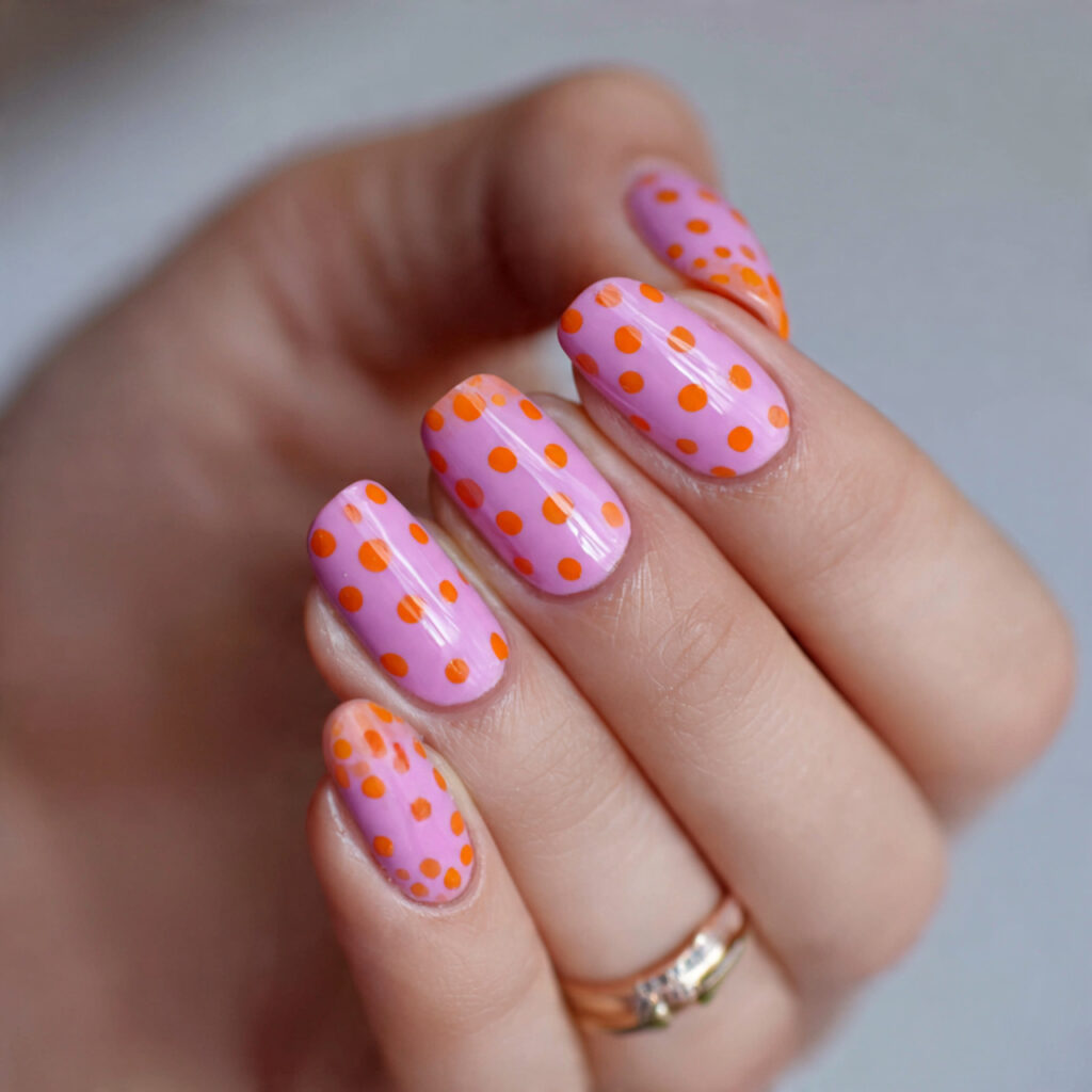 14 Summer Nails Pink and Orange Ideas That Are Literally Too Cute to Ignore 13 pink base with orange polka dots nails