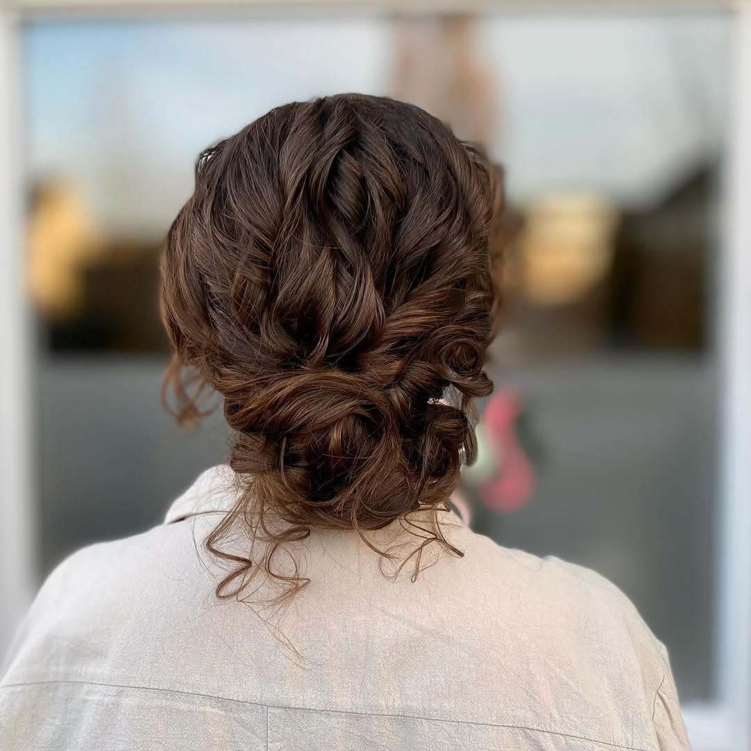 15 Curly Hairstyles for School That Will Make You Want to Ditch the Snooze Button 14 Low Curly Bun with Tendrils