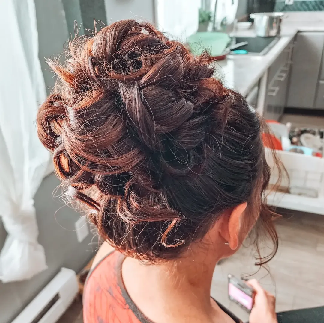 15 Curly Bun Hairstyles That Instantly Upgrade Your Look (No Effort, All Style) 2 Messy High Curly Bun