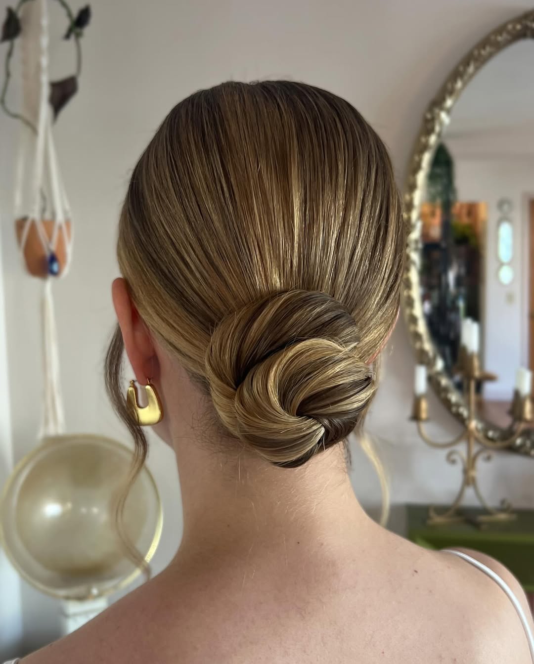 13 Christmas Hairstyles Ideas That’ll Make You the Main Character This Holiday Season 3 Sleek Low Bun with a Twist