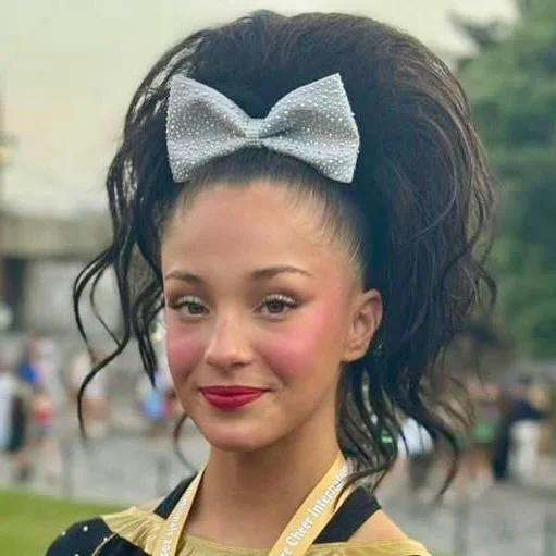 15 Cheer Hairstyle Ideas That’ll Make You Look Game-Day Ready in Seconds 6 Curly Cheer Ponytail
