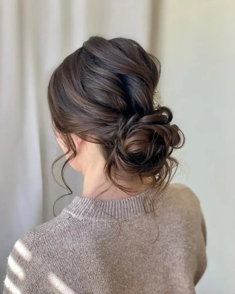 16 Vacation Hairstyles That'll Make You Look Effortlessly Gorgeous (Even After a 10-Hour Flight) 1 The Effortless Messy Bun