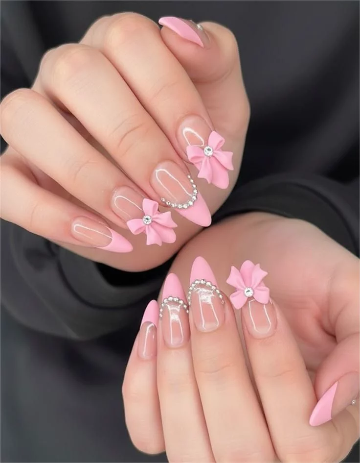 17 Pink Almond Nail Ideas That Are So Pretty, Your Mani Will Break the Group Chat 18 3D Sculpted Pink Bows