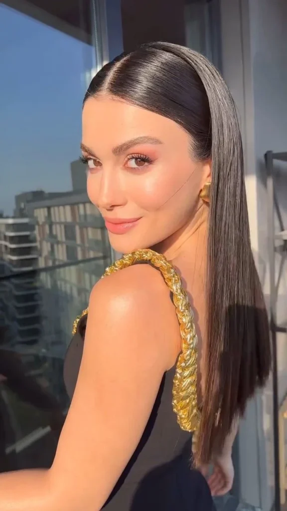 15 Cute Hairstyles for Medium Hair That Look Way Harder Than They Are 10 A Sleek Middle Part With Tucked Ends