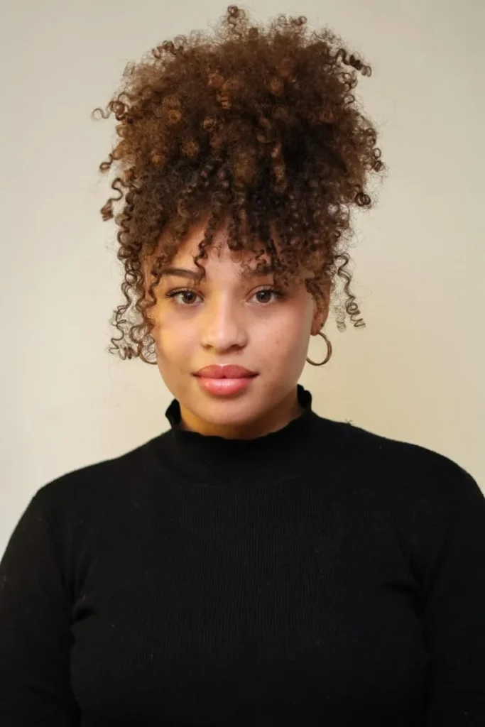 19 Cute Hairstyles for Curly Hair That'll Make You Fall in Love With Your Curls All Over Again 2 The Pineapple Updo