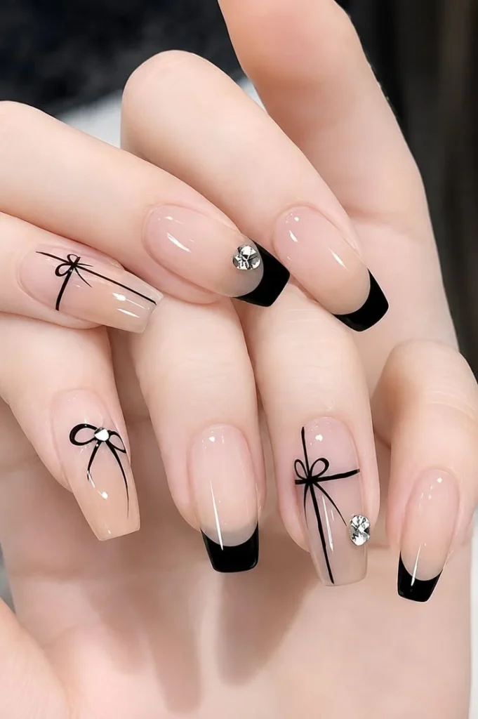 Dark, Festive, and Seriously Chic: 16 Black Christmas Nails for a Stylish Holiday Look 14 Black Nails With Tiny Red Bows