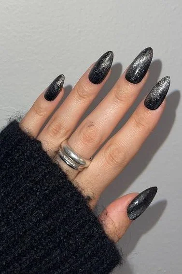 Dark, Festive, and Seriously Chic: 16 Black Christmas Nails for a Stylish Holiday Look 13 Black Velvet Cat Eye Nails