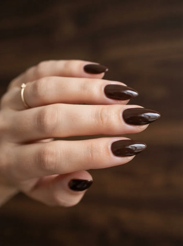 17 Brown Fall Nails That Look Expensive, Cozy, and Perfect for Autumn 5 Deep Brown Almond with Cuticle Shine Brown Fall Nails