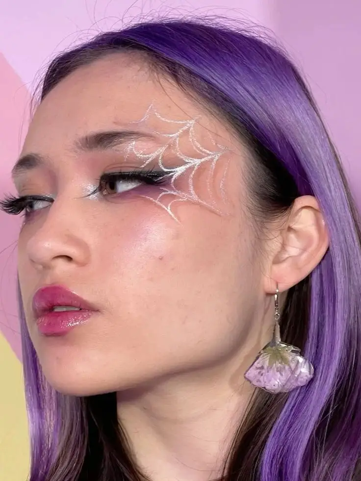 16 Halloween Makeup Looks That Turn a Simple Outfit Into a Whole Costume 1 Glitter Spiderweb Eyes