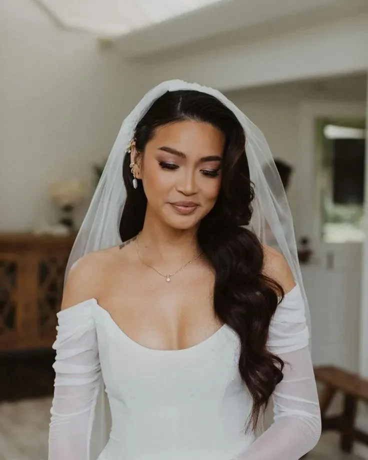 The Bridal Lookbook: 18 Wedding Hairstyles with Veil That Feel Truly Special 2 Loose Hollywood Waves with a Cathedral Veil