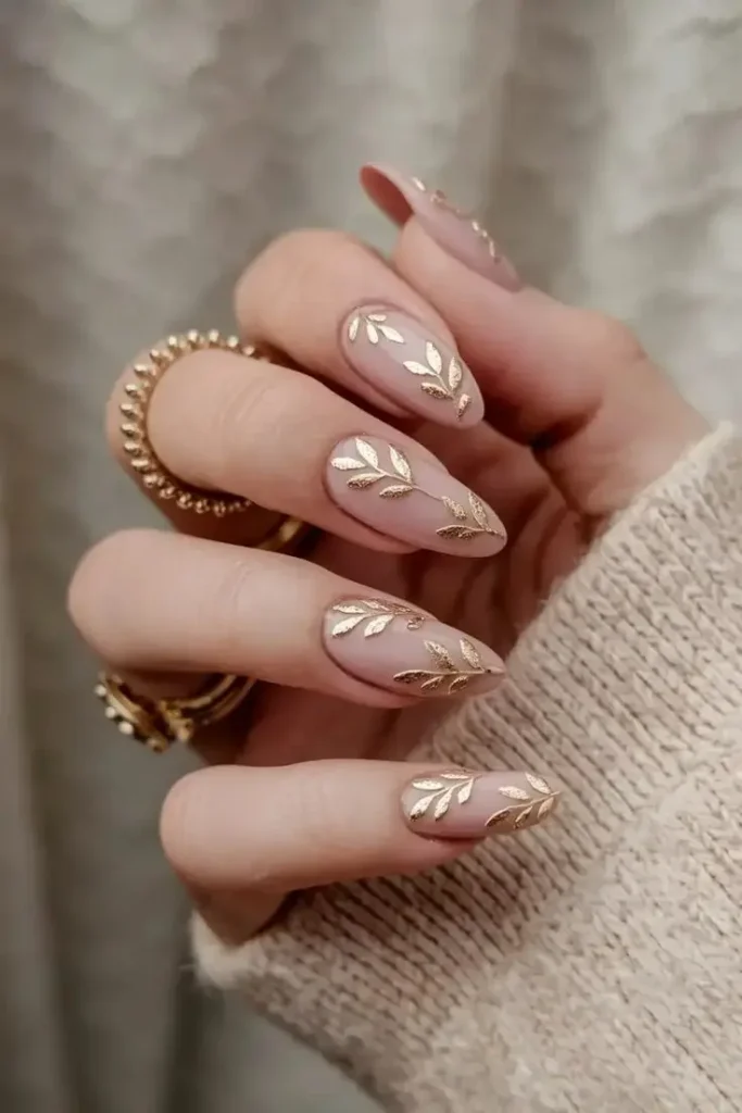 18 Fall Almond Nails That Will Make You Ditch Your Basic Manicure Forever 12 Nude with Delicate Leaf Art