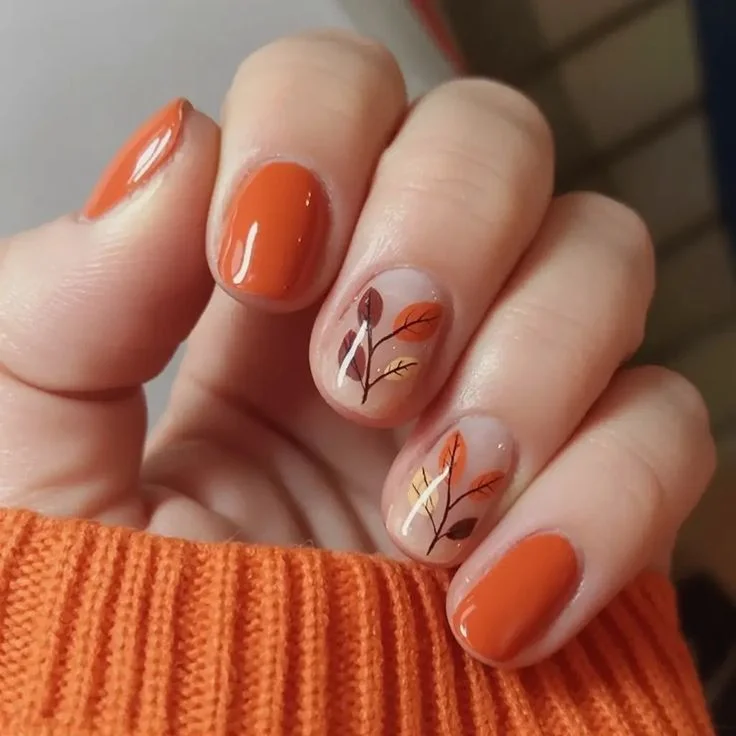 13 Fall Orange Nails That Make Autumn Feel Extra Cozy 9 Orange Nails With Tiny Fall Leaves