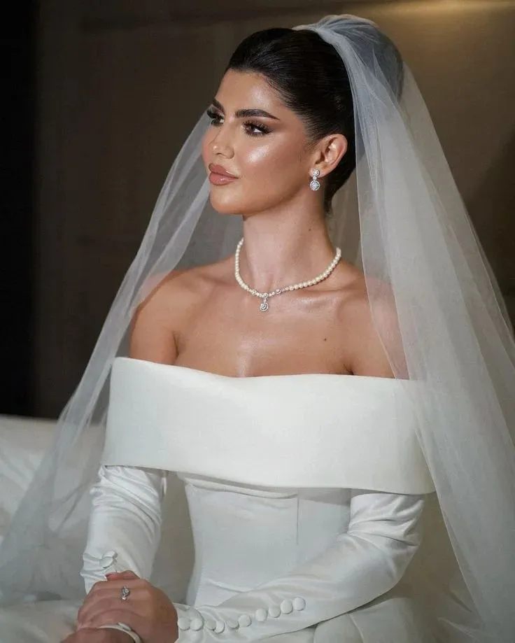 The Bridal Lookbook: 18 Wedding Hairstyles with Veil That Feel Truly Special 4 Sleek High Bun with a Long Veil