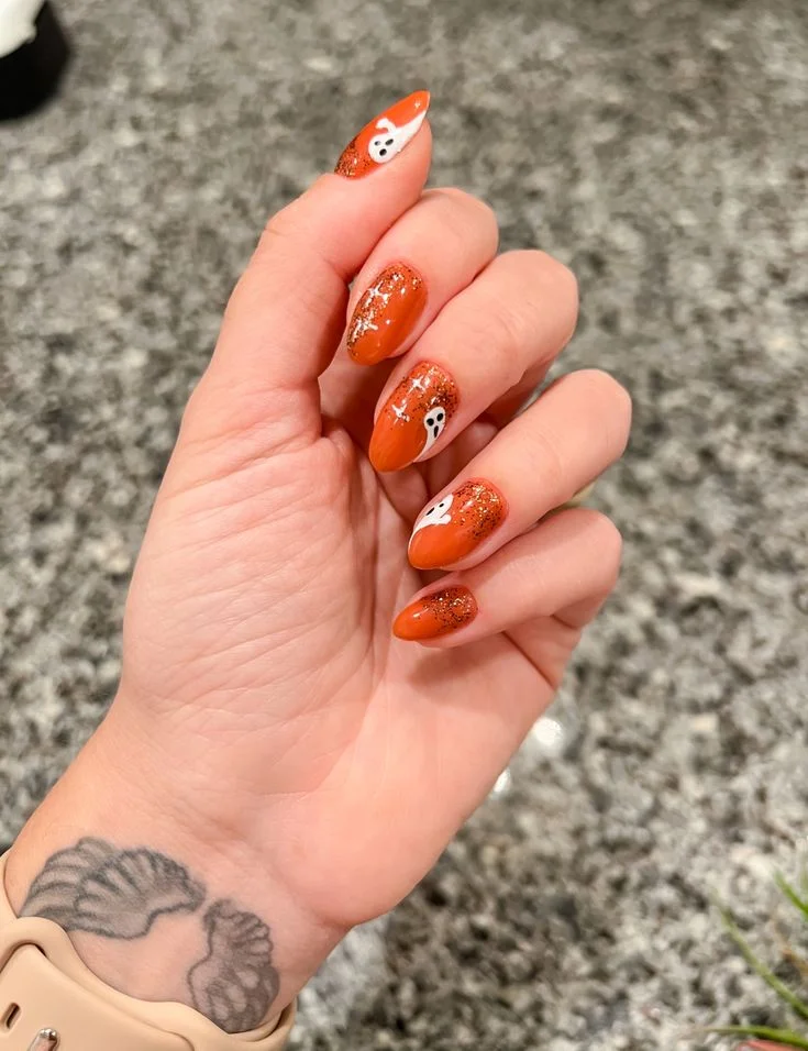Fall Gets Spooky With These 19 Fall Halloween Nails You’ll Want to Copy 2 Burnt Orange Ghost Nails 1