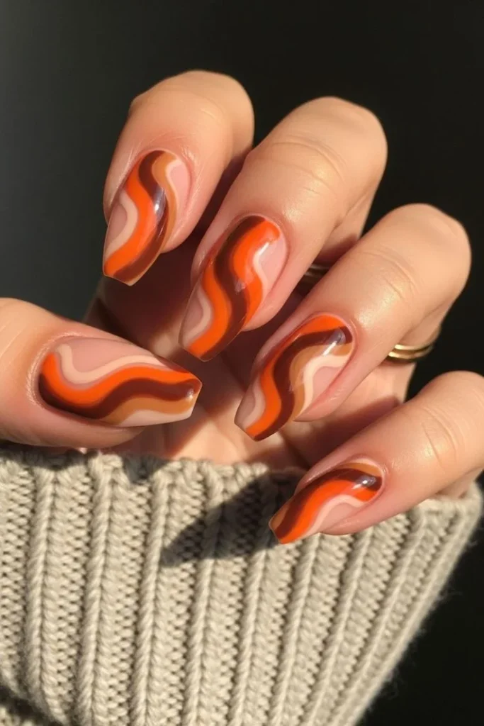 Fall Gets Spooky With These 19 Fall Halloween Nails You’ll Want to Copy 6 Pumpkin Spice Swirl Nails